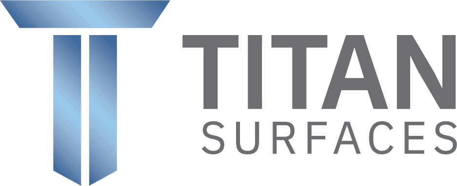 Logo of Titan Surfaces featuring a stylized blue and gray geometric "T" symbol to the left of the text "TITAN SURFACES" in gray letters.